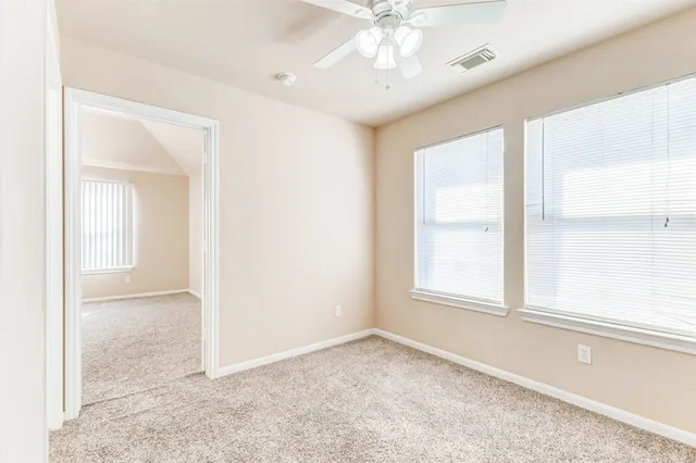 an empty room with windows and closet