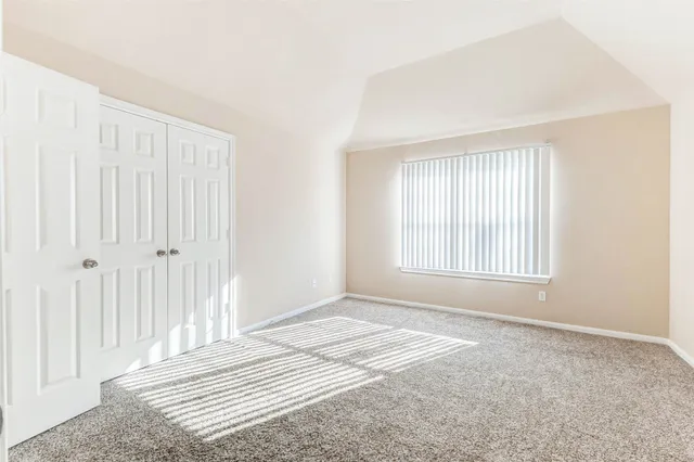 a view of a livingroom with wooden floor and a window