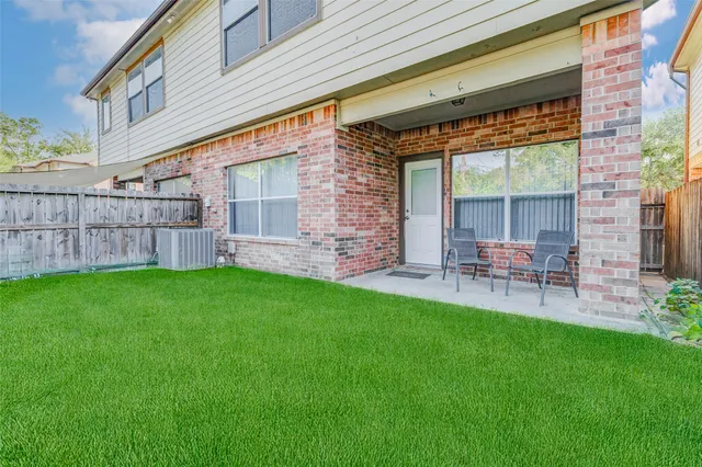 a view of a house with a backyard and a patio