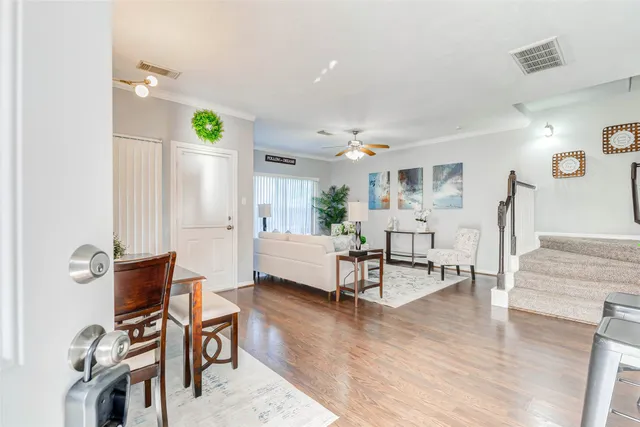 a living room with furniture and wooden floor