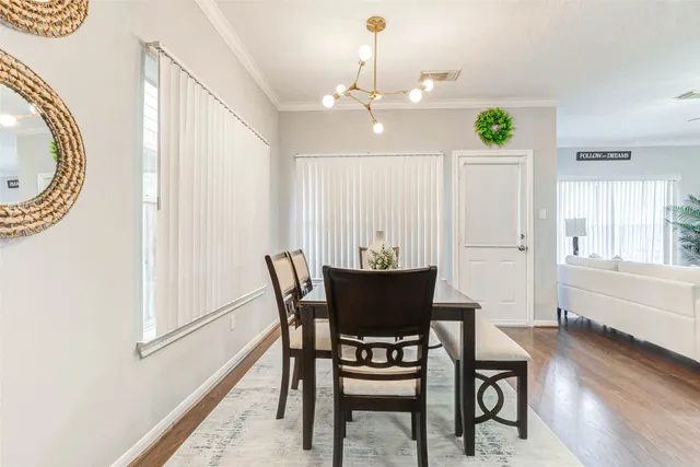 a view of a dining room with furniture and wooden floor