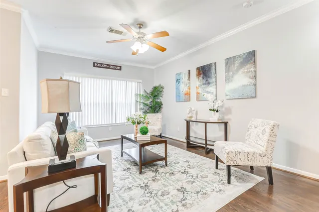 a living room with furniture and wooden floor