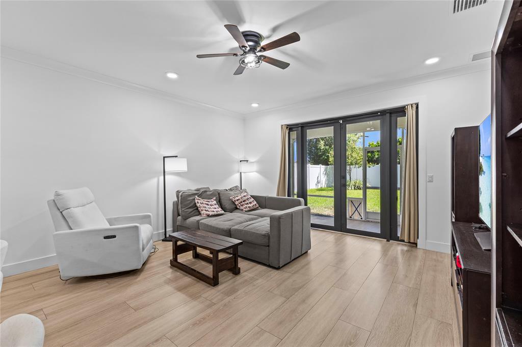 6810 Church Street Jupiter, FL 33458 - Photo 12 of 39 a living room with furniture and a flat screen tv