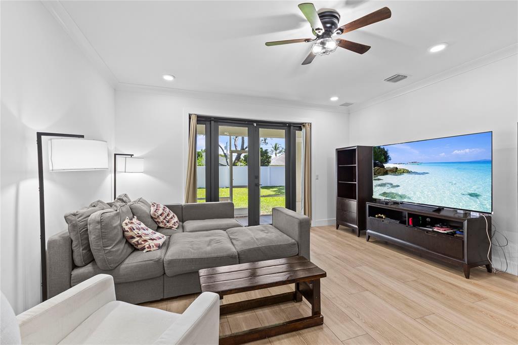 6810 Church Street Jupiter, FL 33458 - Photo 13 of 39 a bedroom with furniture and a flat screen tv