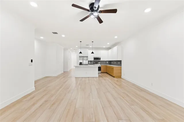 a view of kitchen with refrigerator microwave and stove