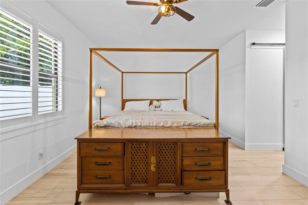 6810 Church Street Jupiter, FL 33458 - Photo 16 of 39 a bedroom with a bed and a dresser