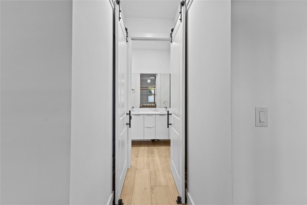 6810 Church Street Jupiter, FL 33458 - Photo 18 of 39 a view of a hallway with a livingroom and a bathroom with sink