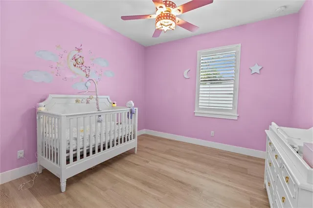 a bedroom with pink walls a bed and a window