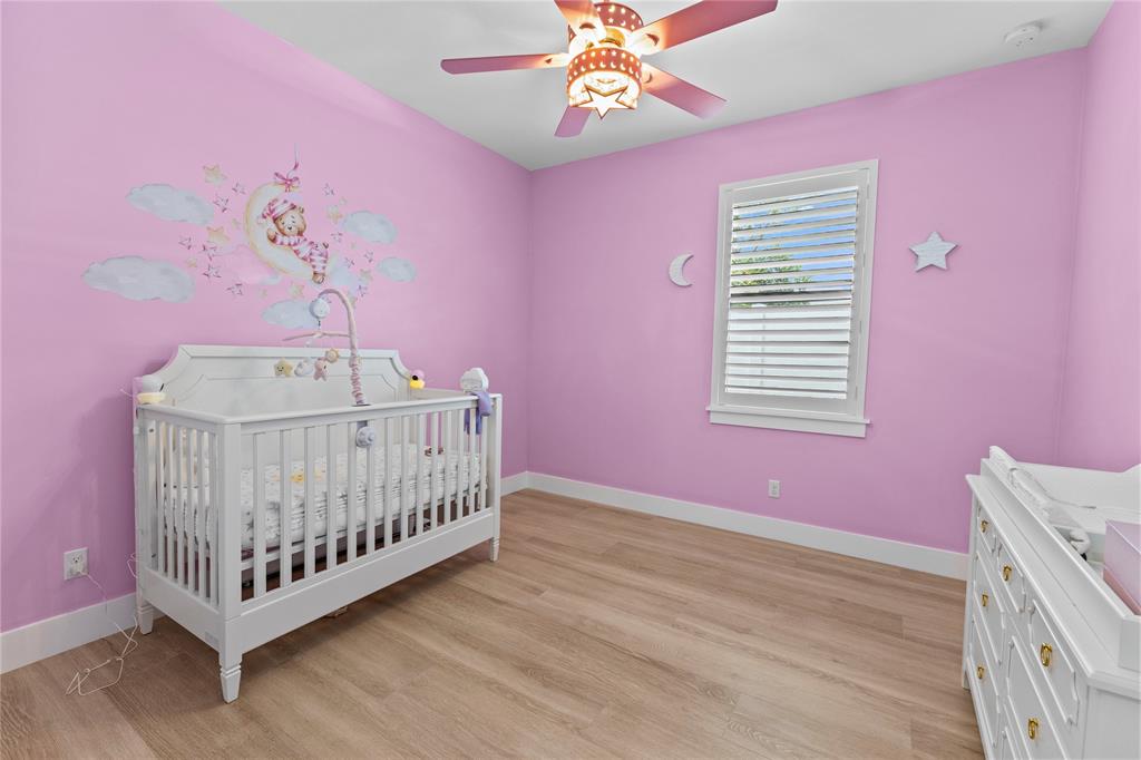 6810 Church Street Jupiter, FL 33458 - Photo 24 of 39 a bedroom with pink walls a bed and a window