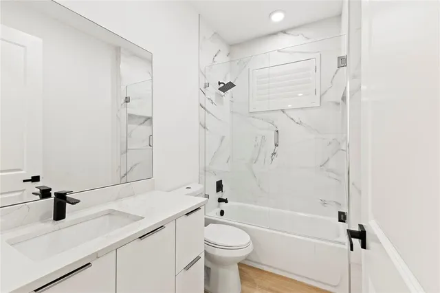 a bathroom with a sink a toilet and a bathtub