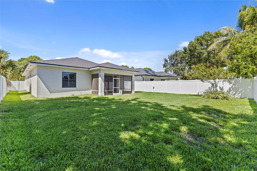 6810 Church Street Jupiter, FL 33458 - Photo 31 of 39 a view of a house with a backyard