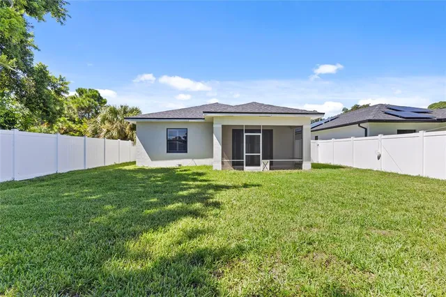 a view of a house with a backyard