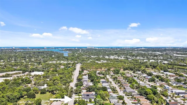 an aerial view of residential houses with city view