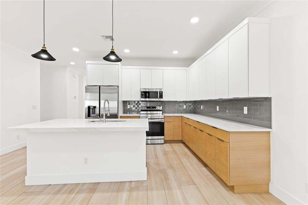 6810 Church Street Jupiter, FL 33458 - Photo 5 of 39 a kitchen with stainless steel appliances granite countertop a sink a stove and a refrigerator