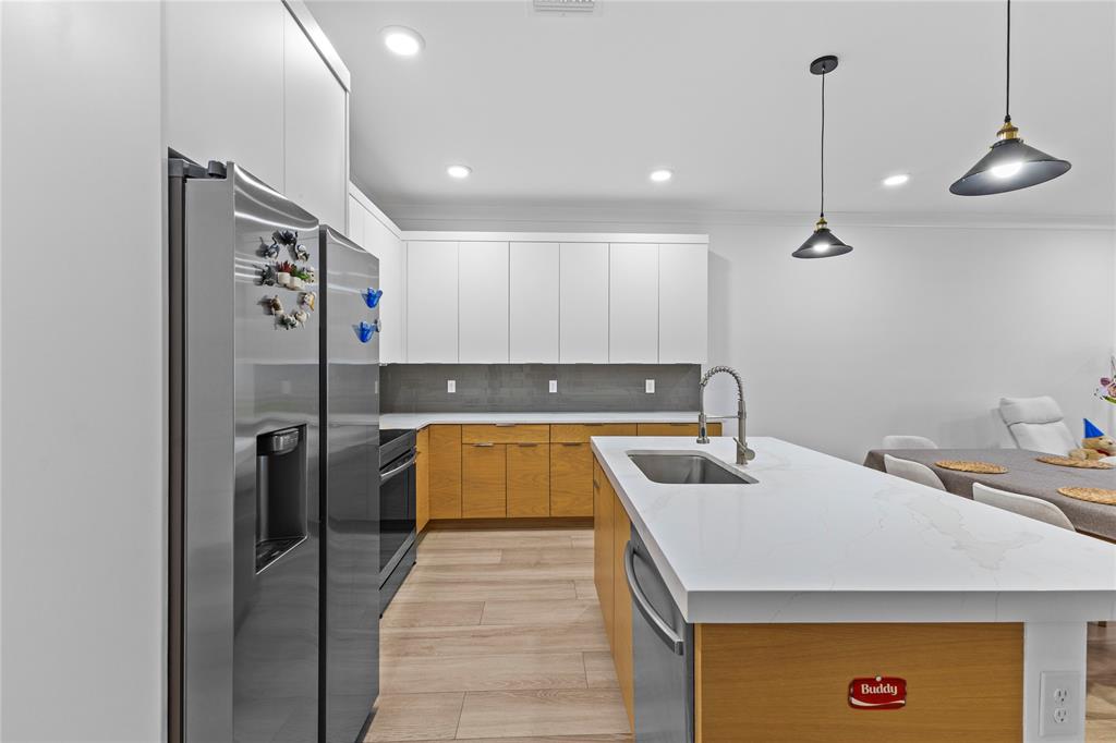 6810 Church Street Jupiter, FL 33458 - Photo 8 of 39 a kitchen with a refrigerator a sink and cabinets