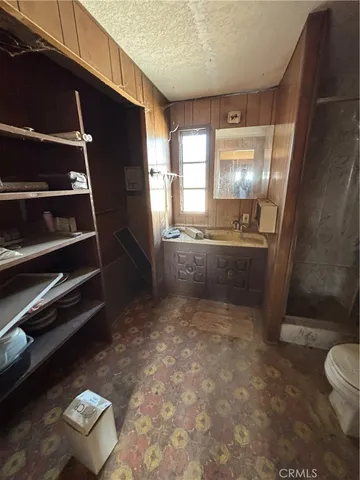 a kitchen with a sink refrigerator and cabinets