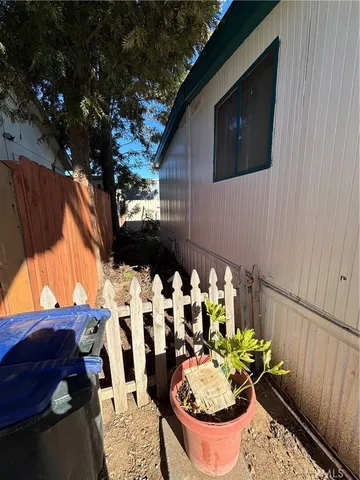 a view of a house with a wooden roof and a bench
