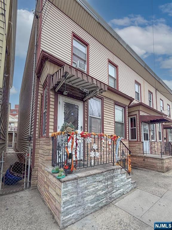 415 Lafayette Street Newark, NJ 07105 - Photo 2 of 2 a view of a white house with large windows and a white roof