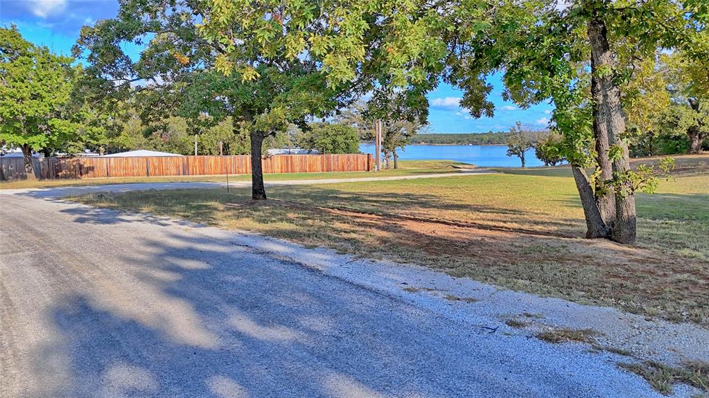 1 Tradewinds Nocona, TX 76255 - Photo 16 of 37 a view of a yard with an trees