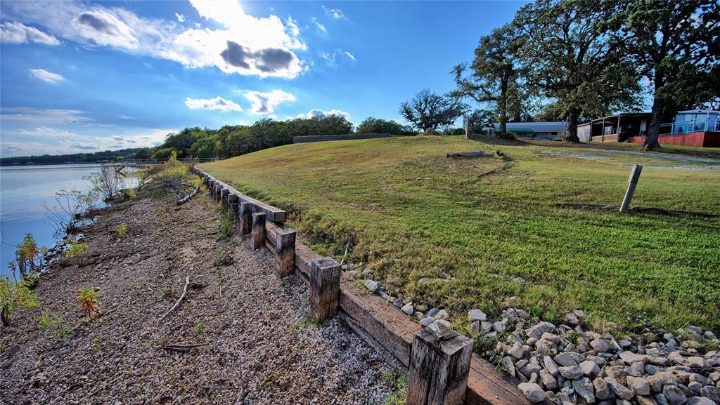 1 Tradewinds Nocona, TX 76255 - Photo 2 of 37 a view of a yard with plants and trees
