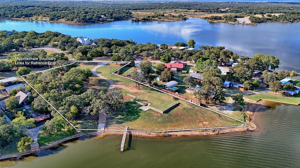 1 Tradewinds Nocona, TX 76255 - Photo 34 of 37 an aerial view of a house with a swimming pool yard and outdoor seating