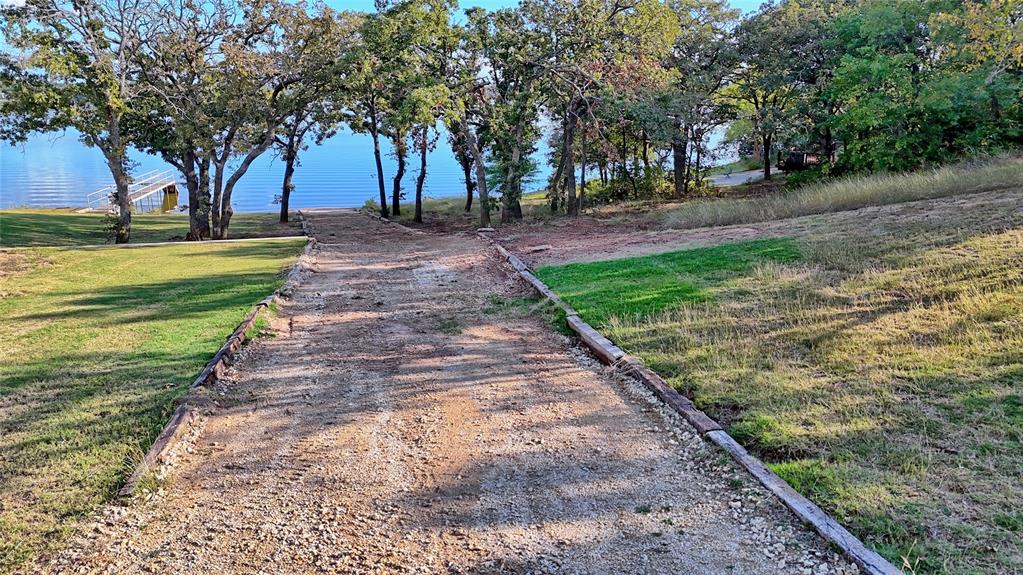 1 Tradewinds Nocona, TX 76255 - Photo 7 of 37 a view of a yard with palm trees