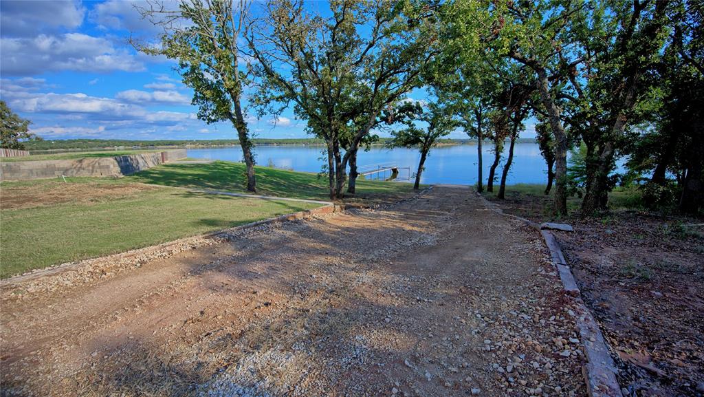 1 Tradewinds Nocona, TX 76255 - Photo 10 of 37 a view of a yard with tree s