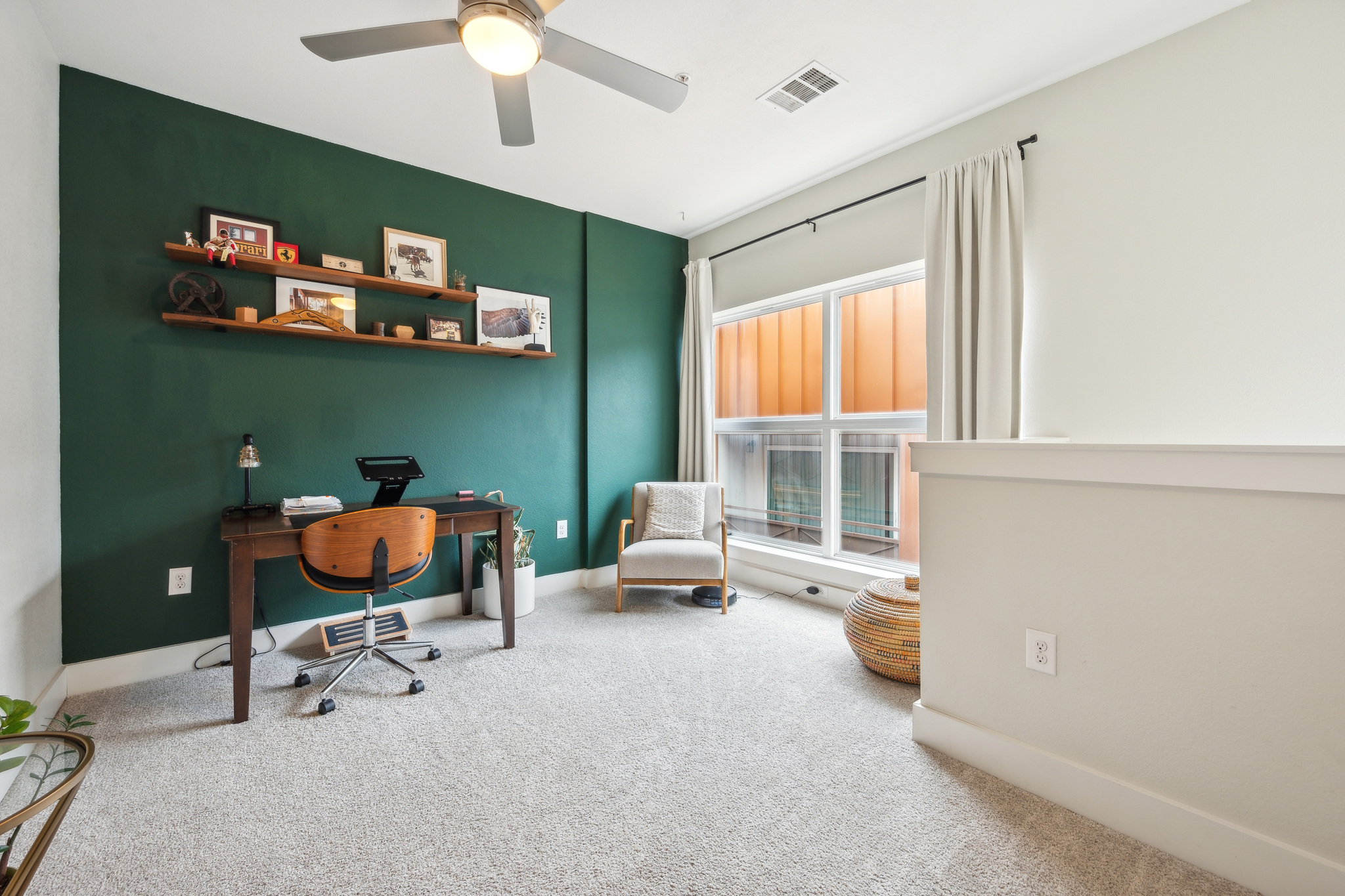 2827 Manor Road, Unit 3104 Austin, TX 78722 - Photo 15 of 30 A versatile home office area with rich green accent walls and plush carpet offers an inspiring workspace.