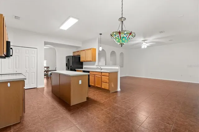 a kitchen with kitchen island a sink stainless steel appliances and cabinets