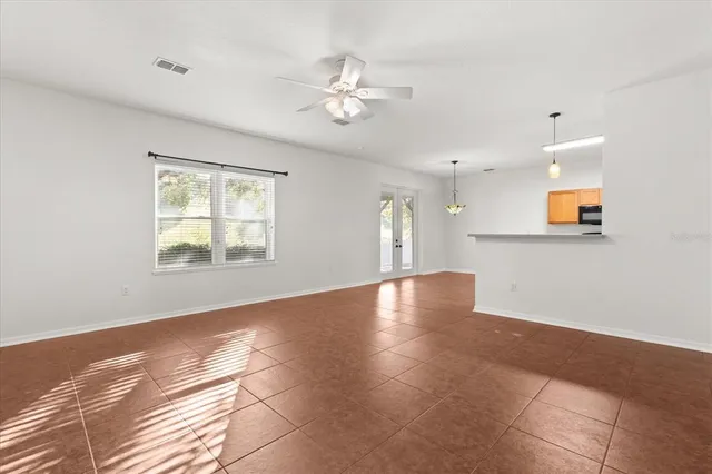 a view of a livingroom with wooden floor and a ceiling fan