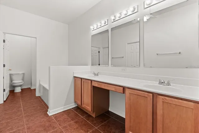 a spacious bathroom with a sink and a mirror