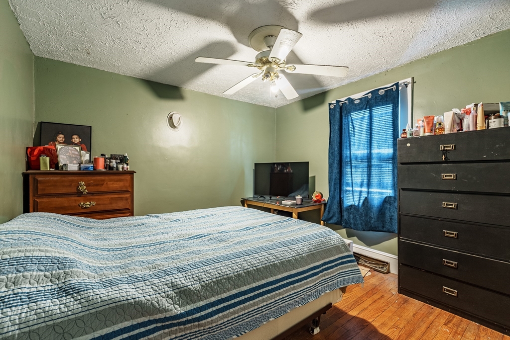 170 Eddy Street Springfield, MA 01104 - Photo 15 of 25 a bedroom with a bed and a flat tv screen on dresser