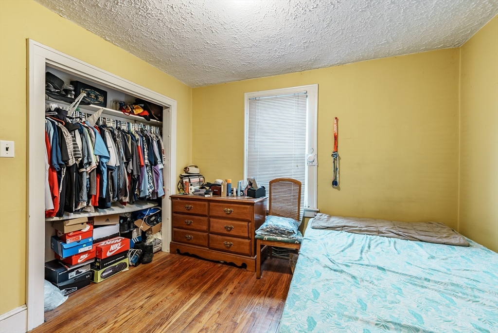 170 Eddy Street Springfield, MA 01104 - Photo 18 of 25 a living room with lots of furniture and closet