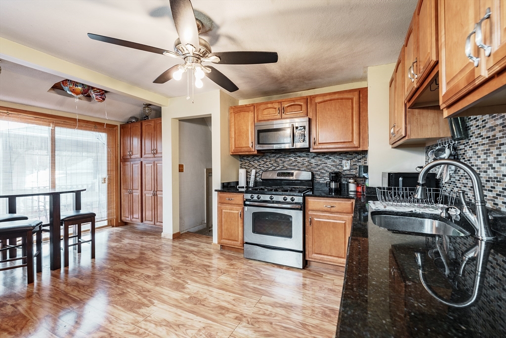 170 Eddy Street Springfield, MA 01104 - Photo 4 of 25 a kitchen with stainless steel appliances granite countertop a stove cabinets and a sink