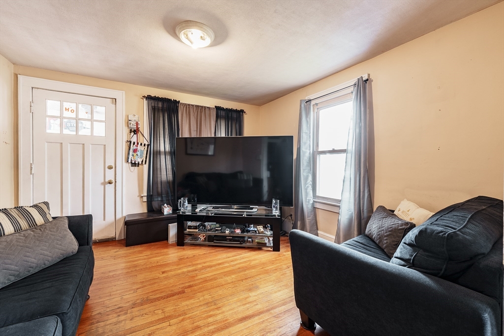 170 Eddy Street Springfield, MA 01104 - Photo 8 of 25 a living room with furniture and a flat screen tv