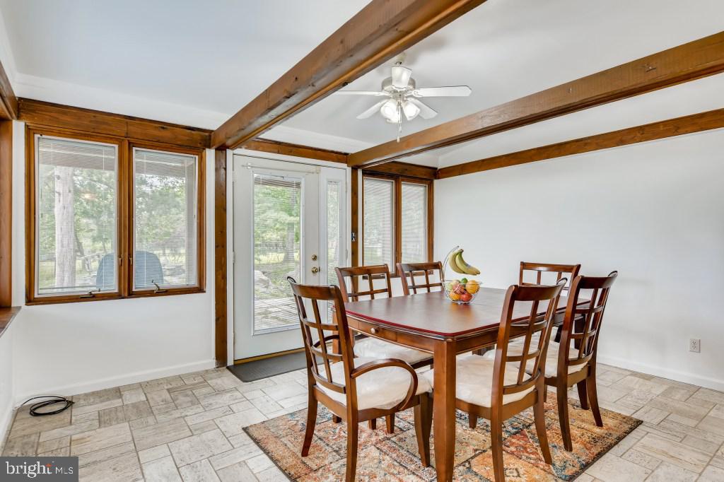 3714 Campfield Road Baltimore, MD 21207 - Photo 12 of 32 a dining room with furniture and large windows