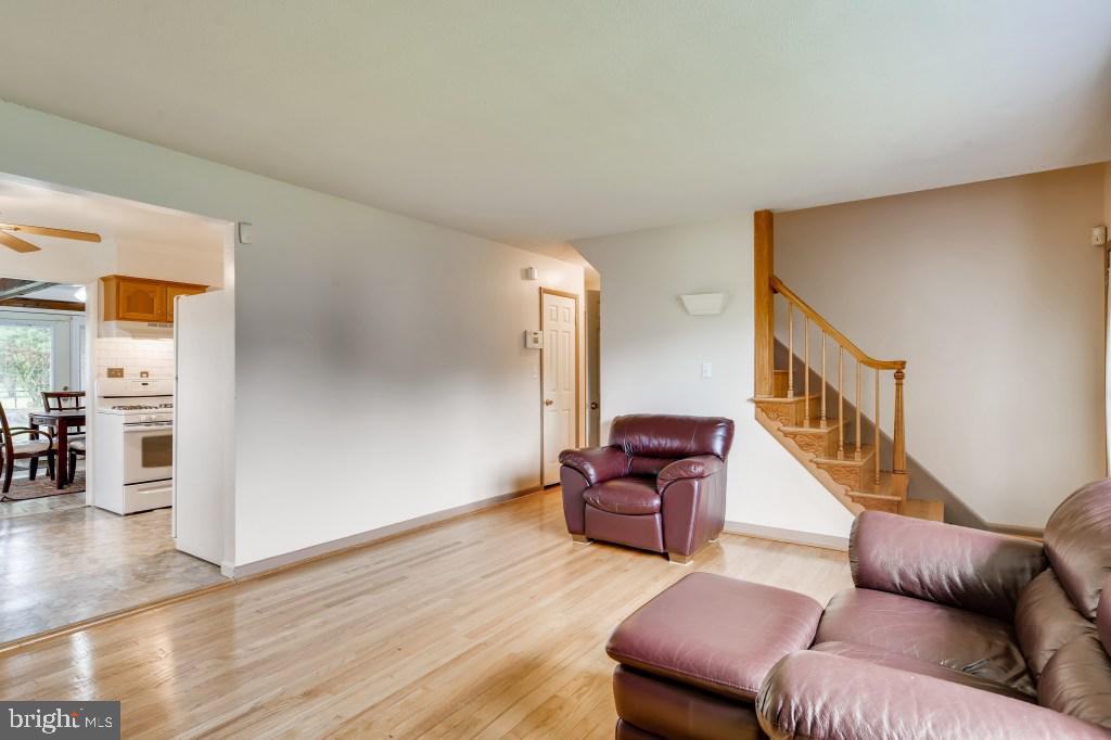 3714 Campfield Road Baltimore, MD 21207 - Photo 14 of 32 a living room with furniture and stairs