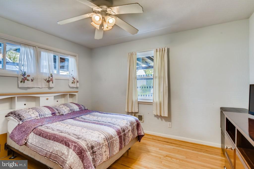3714 Campfield Road Baltimore, MD 21207 - Photo 15 of 32 a bedroom with a bed and a chandelier