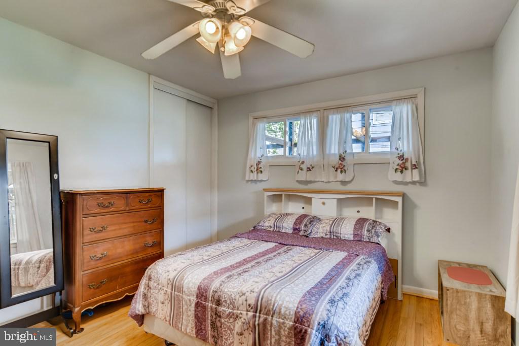 3714 Campfield Road Baltimore, MD 21207 - Photo 16 of 32 a bedroom with a bed and a chandelier