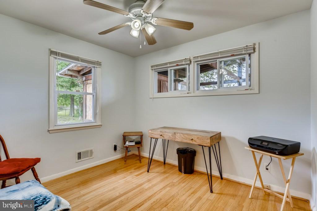 3714 Campfield Road Baltimore, MD 21207 - Photo 19 of 32 a view of a workspace with furniture and a window