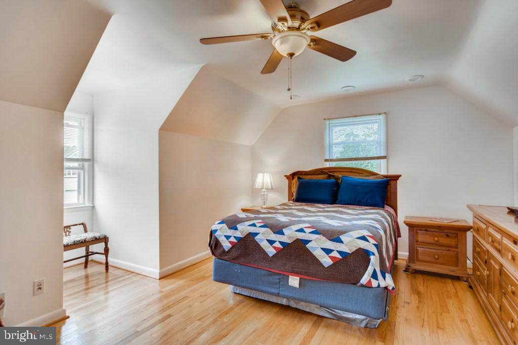 3714 Campfield Road Baltimore, MD 21207 - Photo 21 of 32 a bedroom with a bed and wooden floor