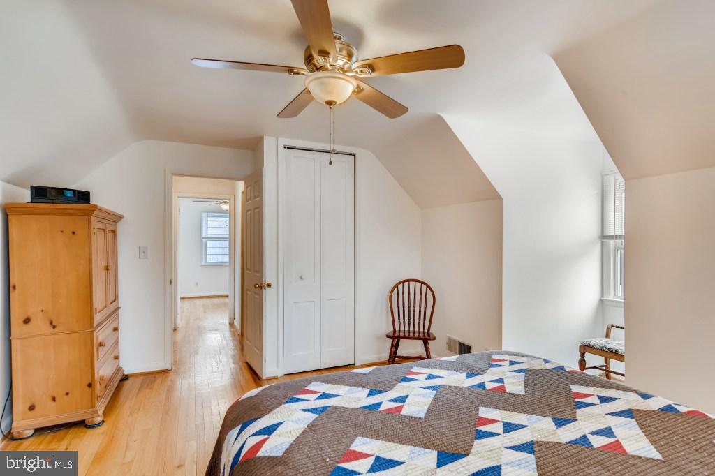 3714 Campfield Road Baltimore, MD 21207 - Photo 22 of 32 a bedroom with a bed and a chandelier