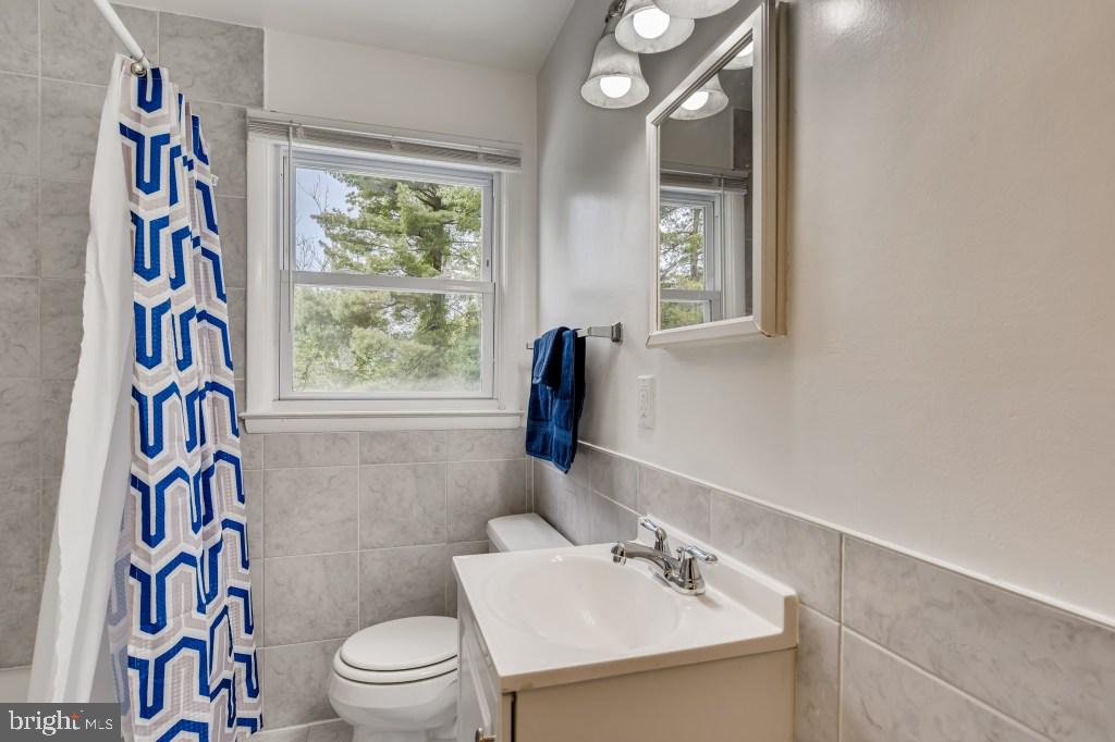 3714 Campfield Road Baltimore, MD 21207 - Photo 23 of 32 a bathroom with a sink a toilet and a window
