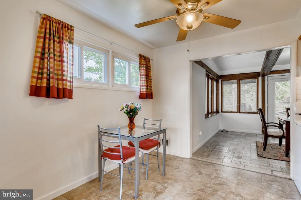 3714 Campfield Road Baltimore, MD 21207 - Photo 7 of 32 a dining room with chandelier fan and wooden floor