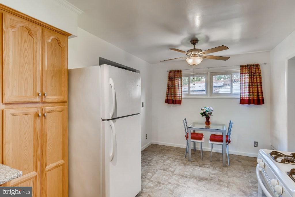 3714 Campfield Road Baltimore, MD 21207 - Photo 10 of 32 a kitchen with stainless steel appliances granite countertop a refrigerator and a sink