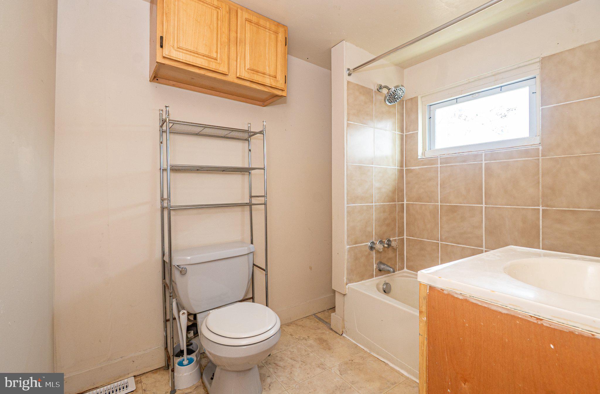 423 Furrow Street Baltimore, MD 21223 - Photo 16 of 24 a bathroom with a sink a toilet and shower