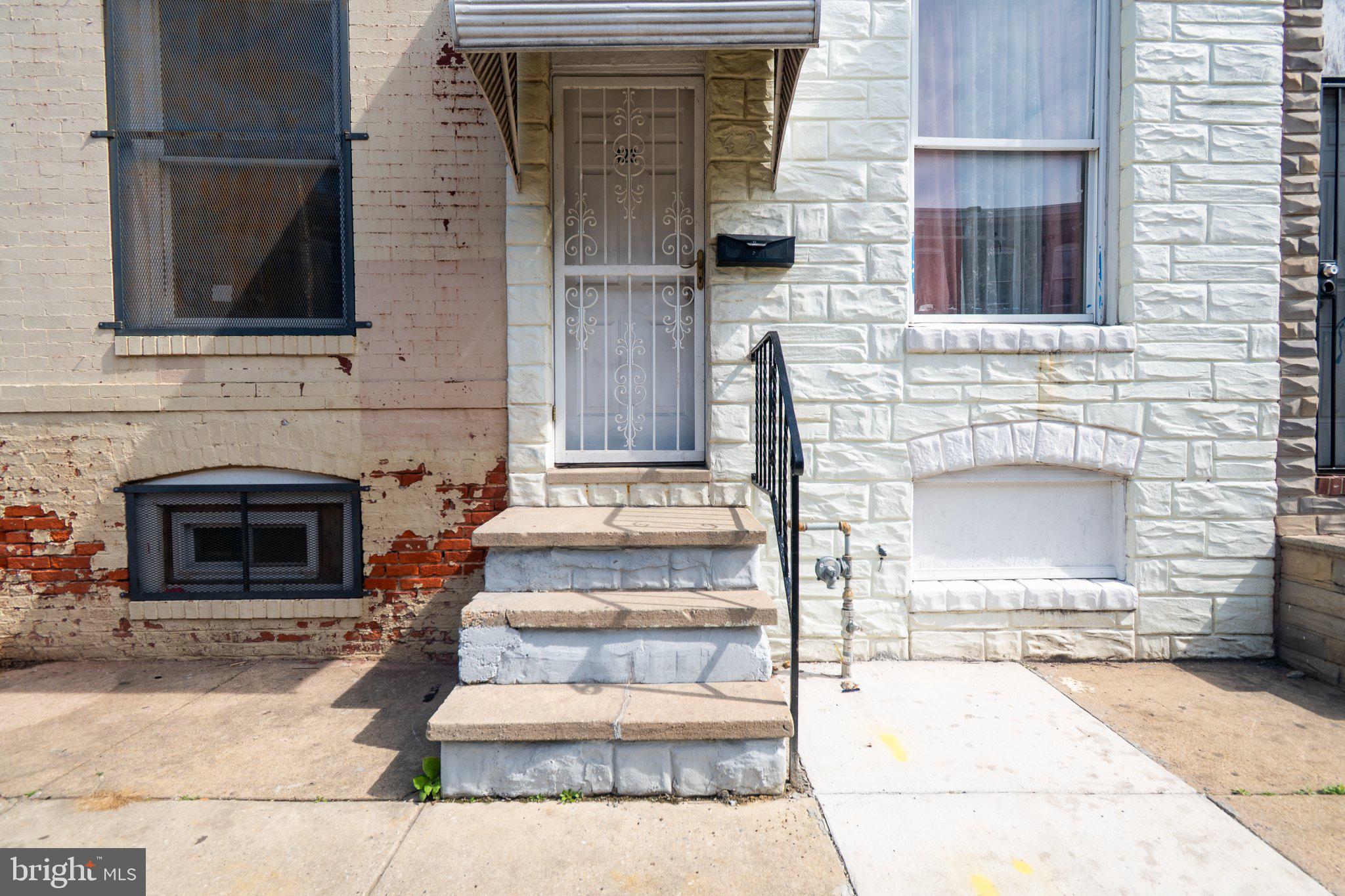 423 Furrow Street Baltimore, MD 21223 - Photo 3 of 24 a front view of a house with stairs