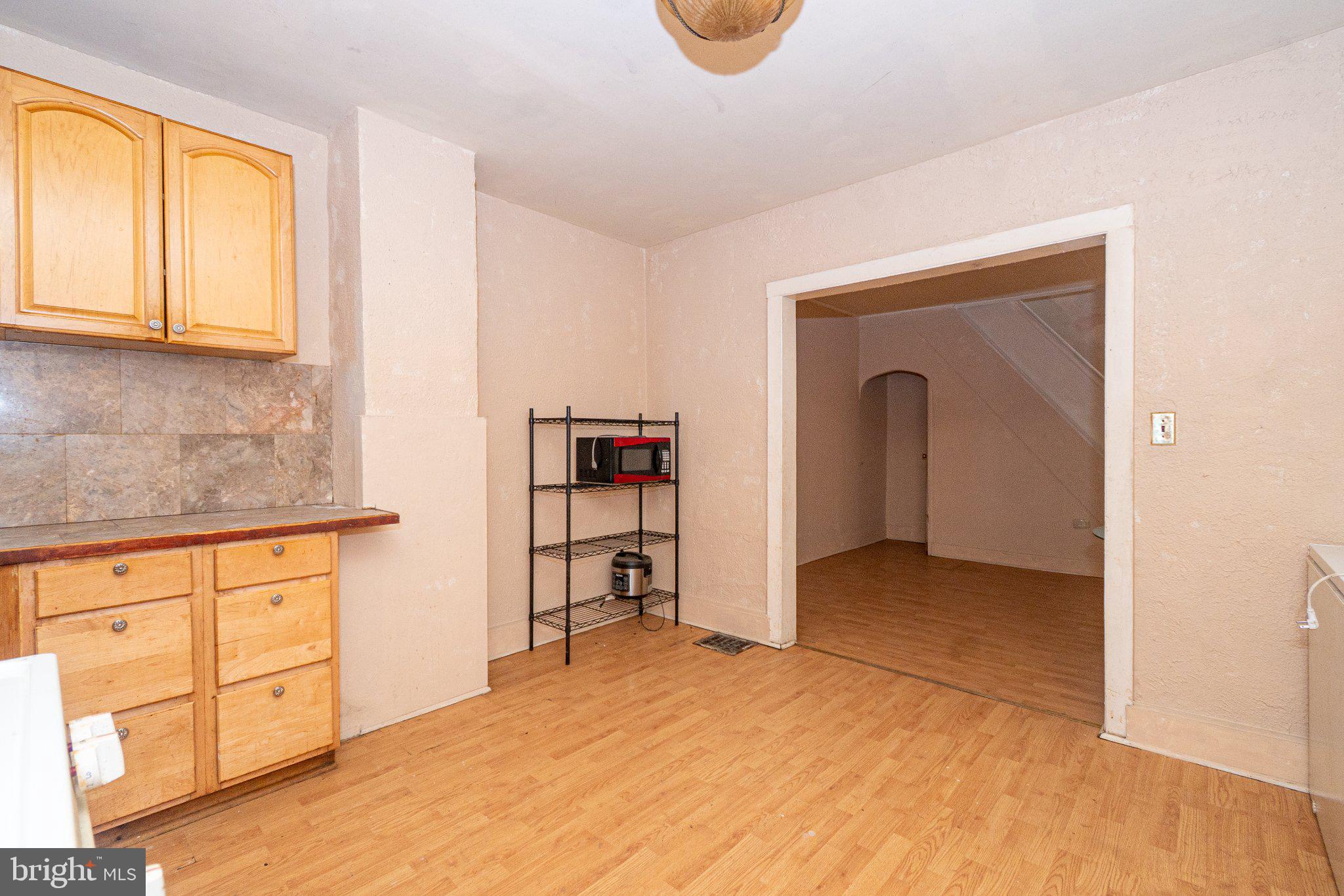 423 Furrow Street Baltimore, MD 21223 - Photo 9 of 24 a view of empty room with cabinet and window