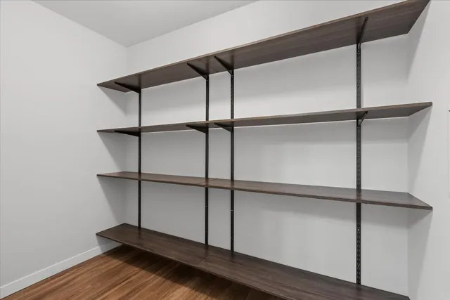 a an empty room with wooden floor