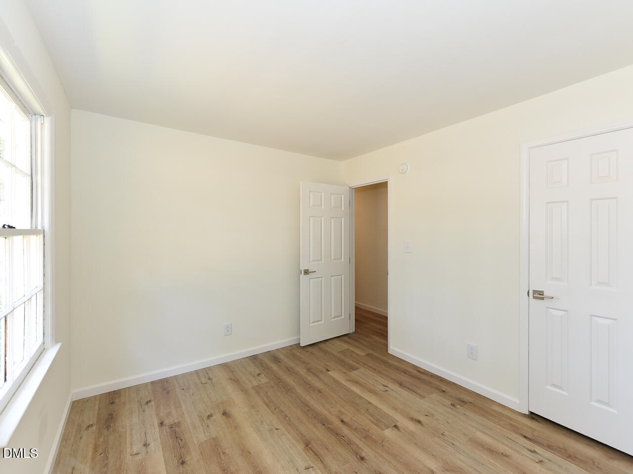 939 Cheves Road Zebulon, NC 27597 - Photo 18 of 21 an empty room with wooden floor and windows